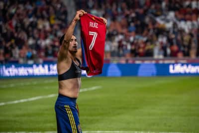 Pablo Ruiz holds up his jersey in celebration during a match.