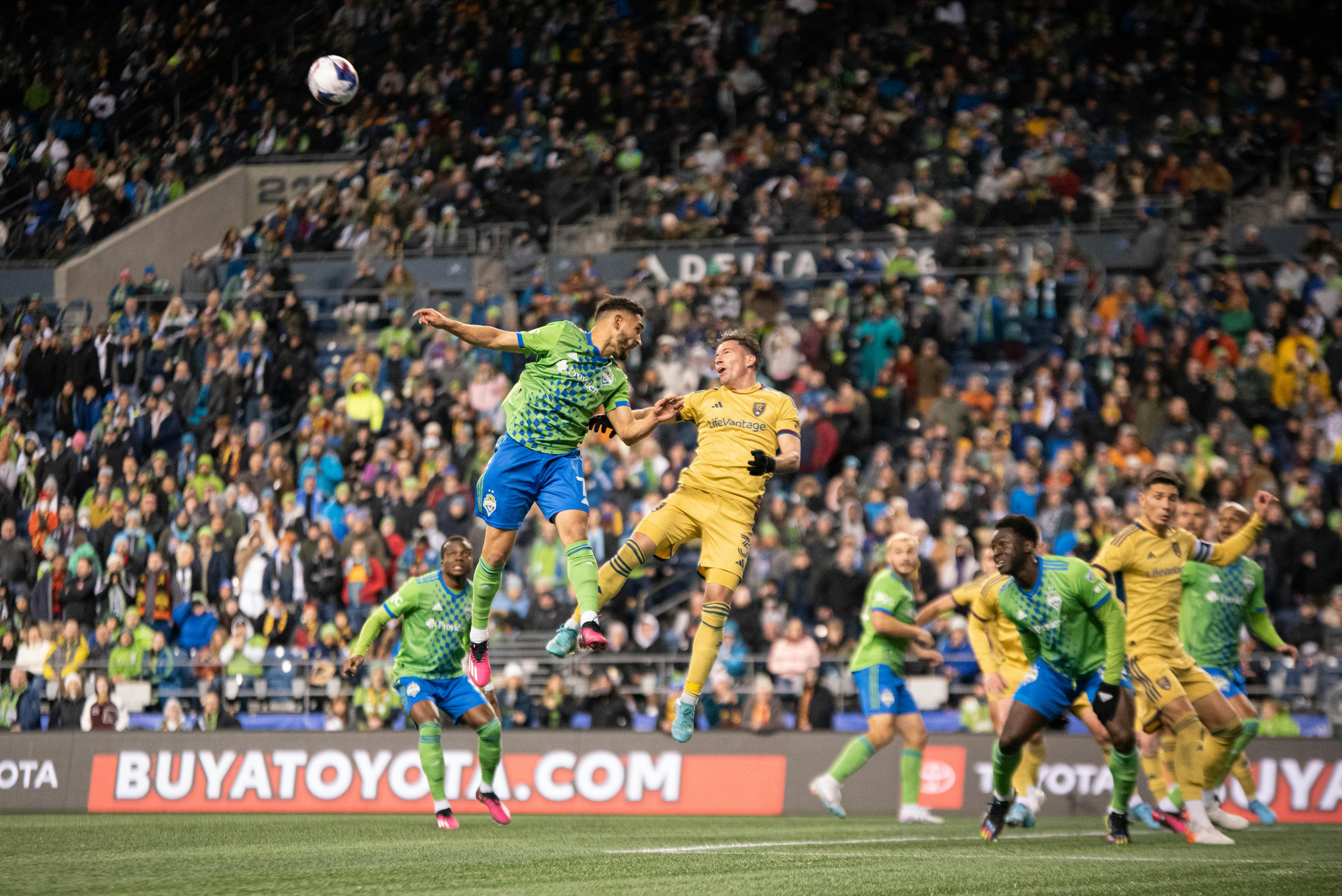 Bryan Oviedo and Cristian Roldan battle for a ball in the air